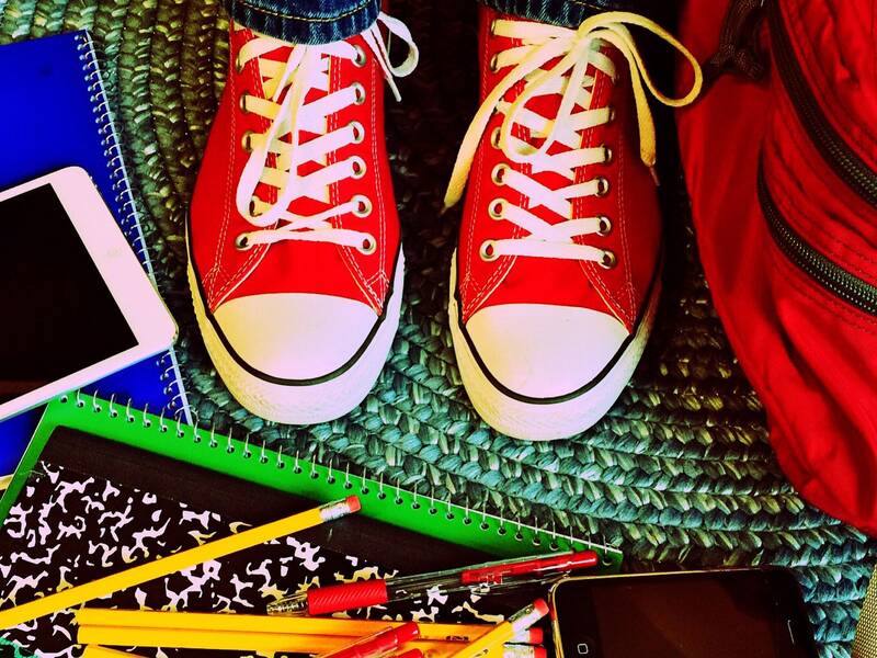 Abbildung von den Schuhen eines Teenagers umgeben von Schulbüchern und einem Schulrucksack